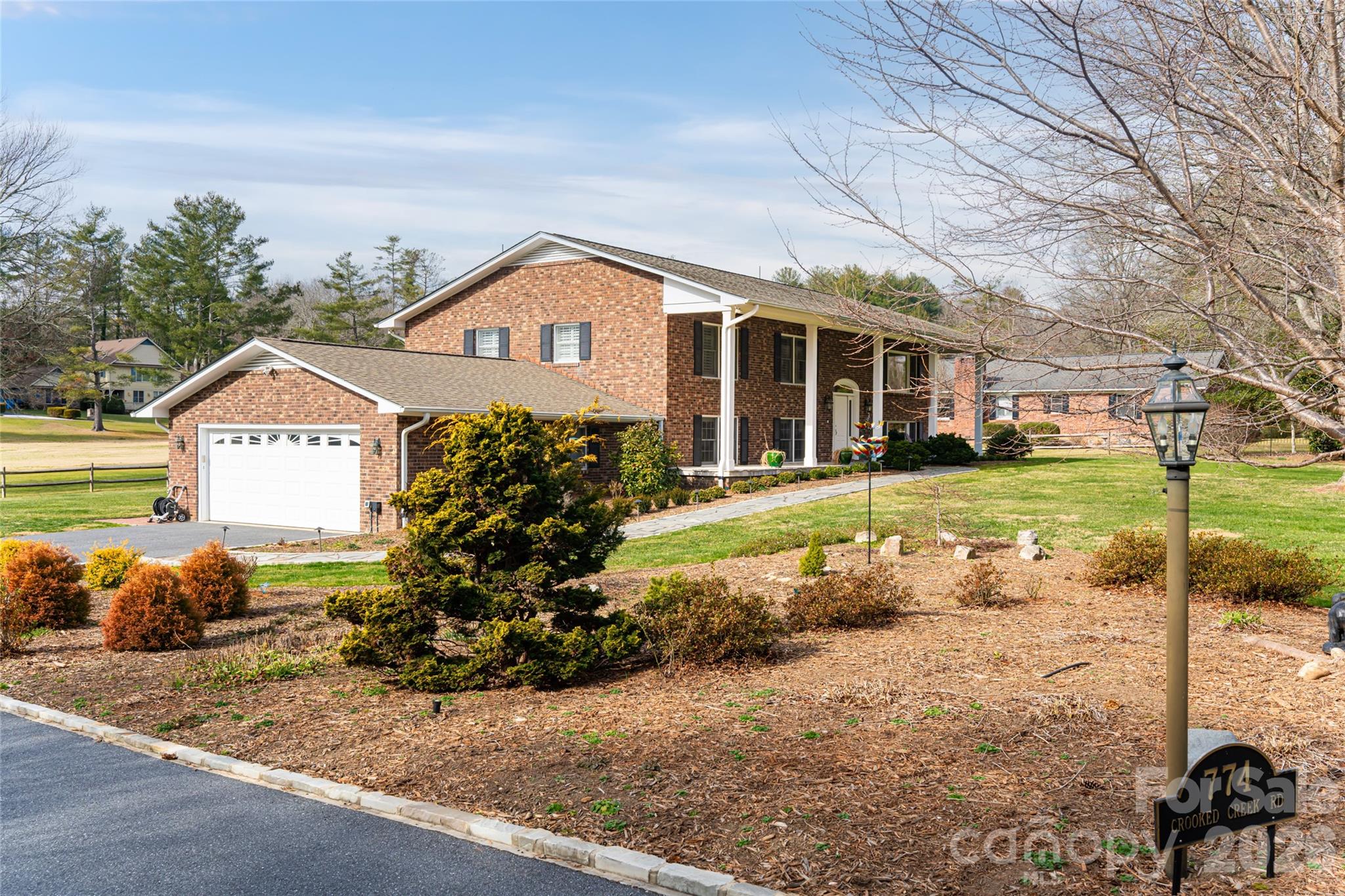 774 Crooked Creek Road Hendersonville, NC 28739 - Photo 41 of 46 a front view of a house with garden
