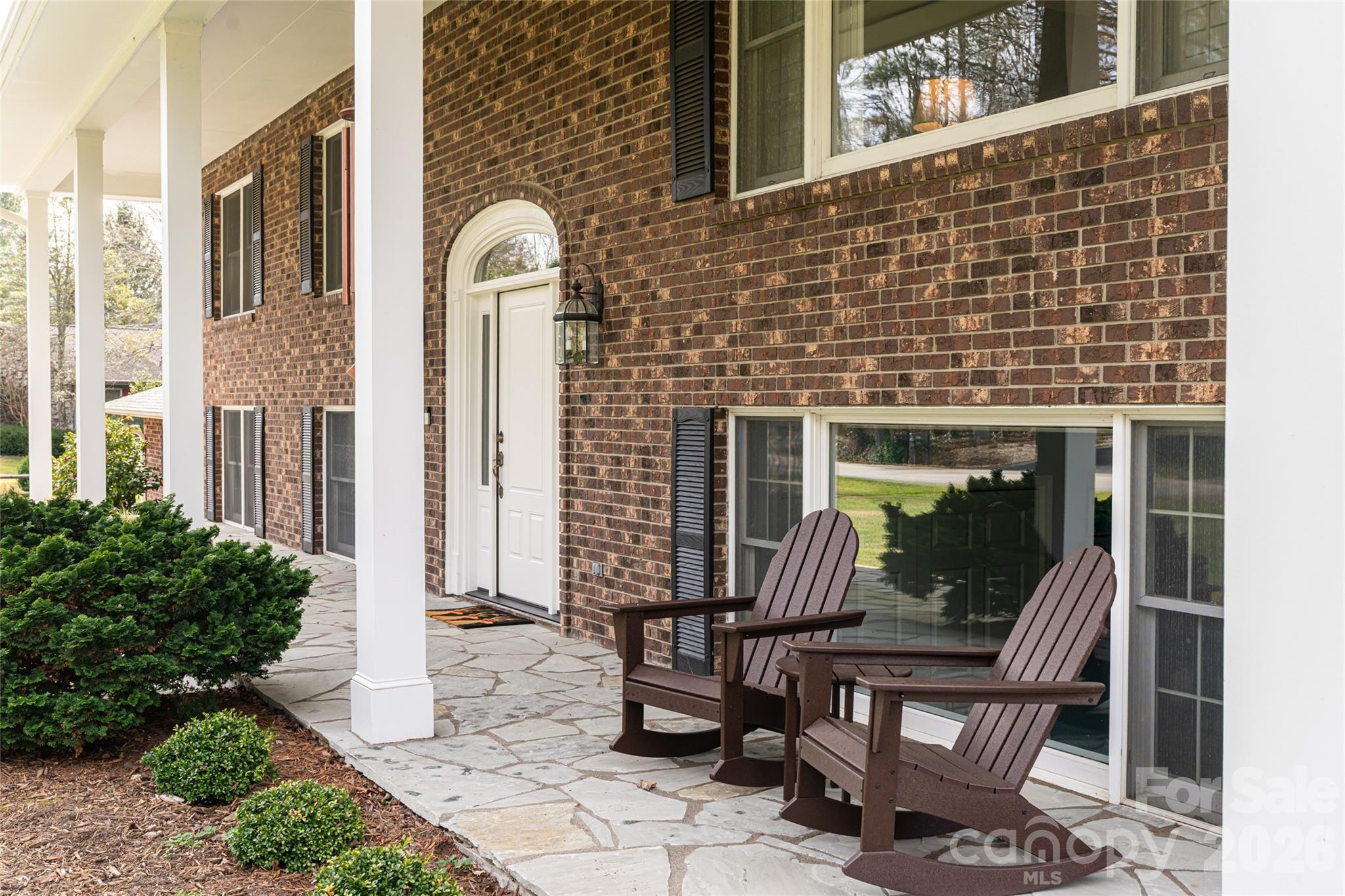 774 Crooked Creek Road Hendersonville, NC 28739 - Photo 6 of 46 a front view of a house with outdoor seating