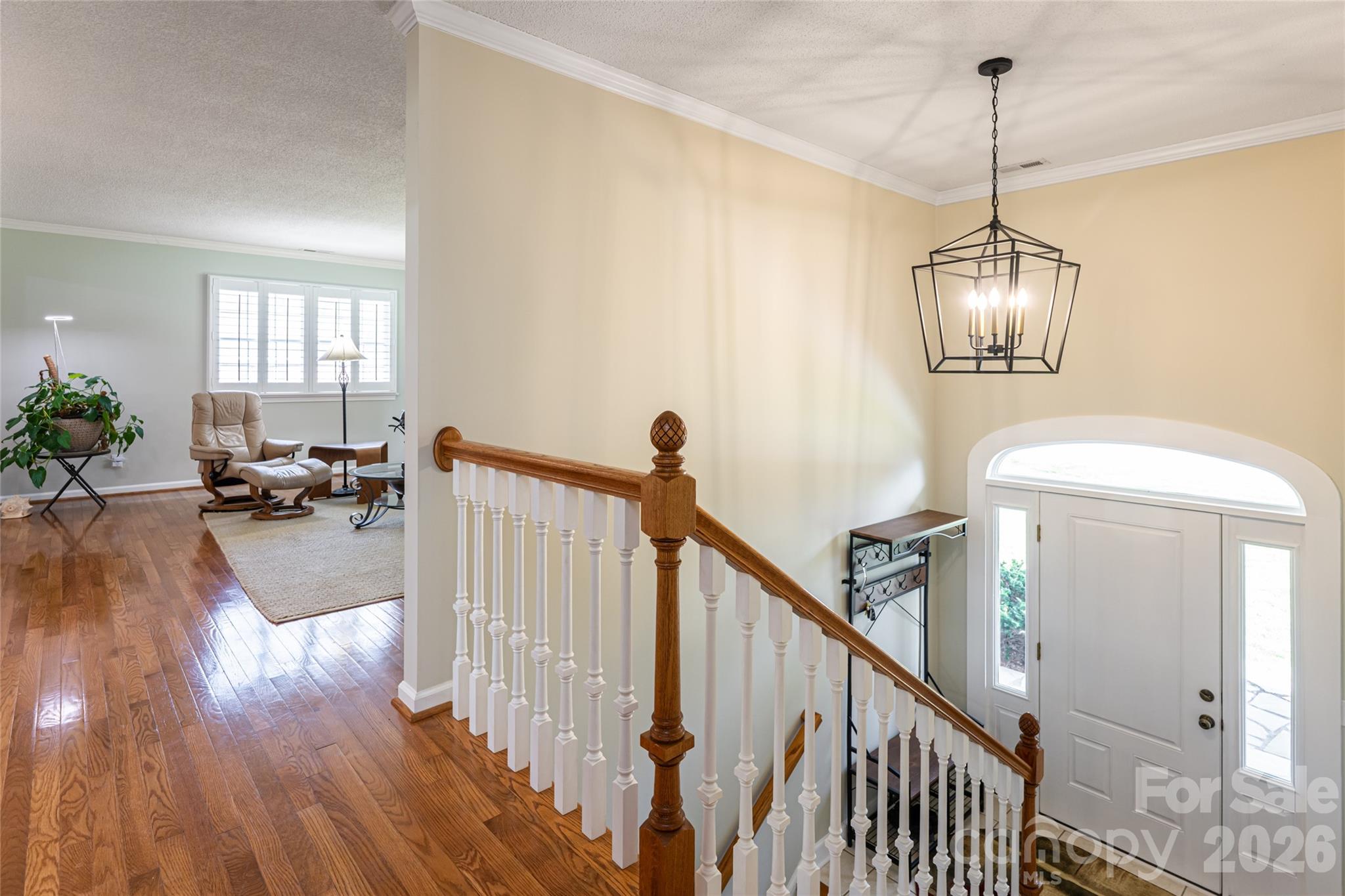 774 Crooked Creek Road Hendersonville, NC 28739 - Photo 7 of 46 a view of a room with wooden floor and stairs