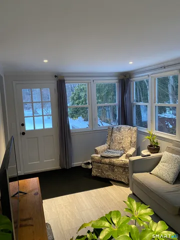 a living room with furniture and large window