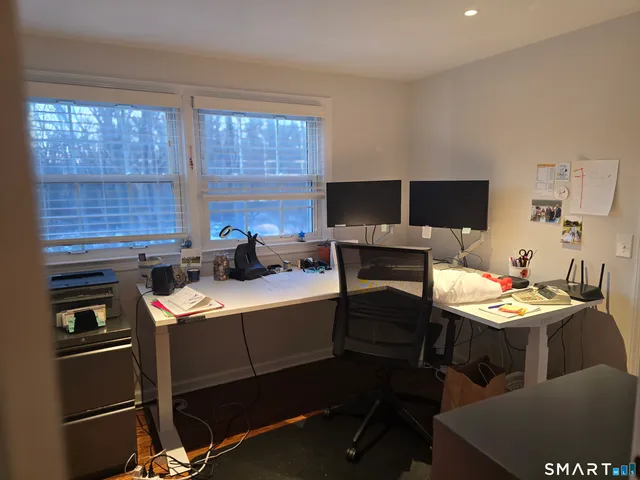 a room with stainless steel appliances kitchen island granite countertop a stove a sink and a microwave