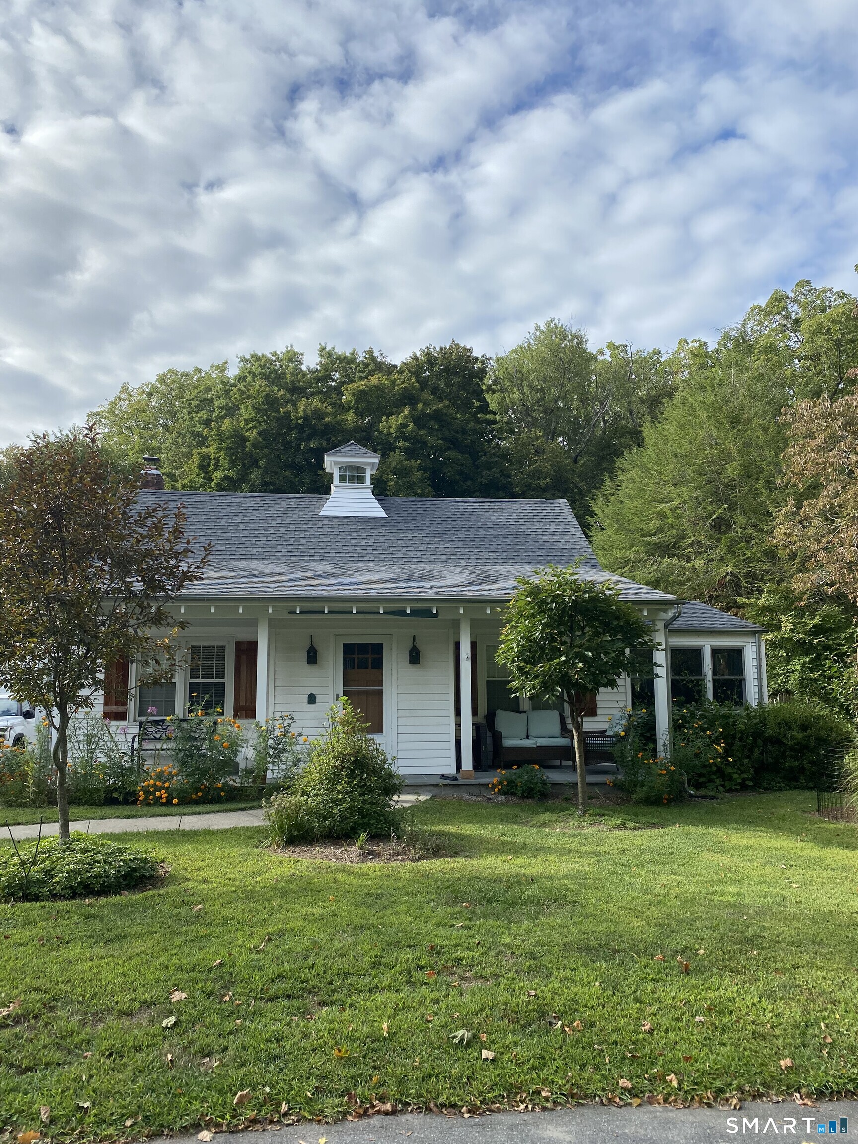 276 Dunnlea Road Fairfield, CT 06824 - Photo 2 of 26 a front view of a house with a yard