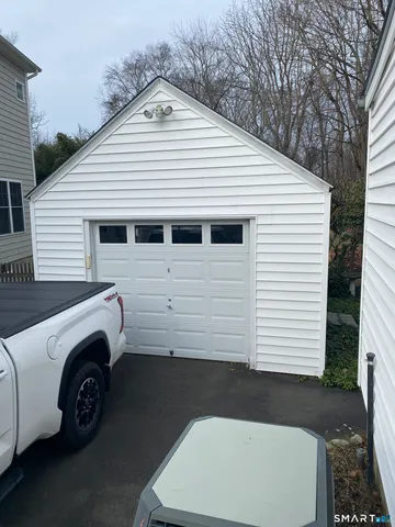 a view of a white house with a garage