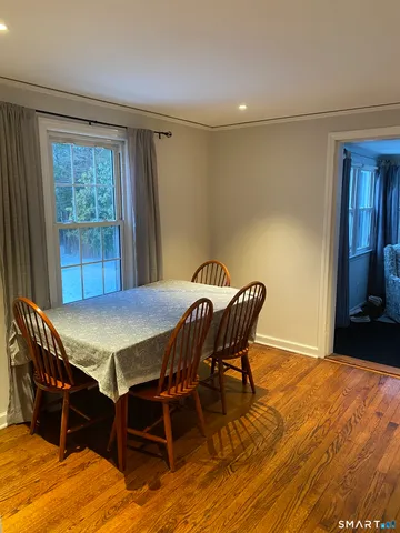 a view of a dining room with furniture and window