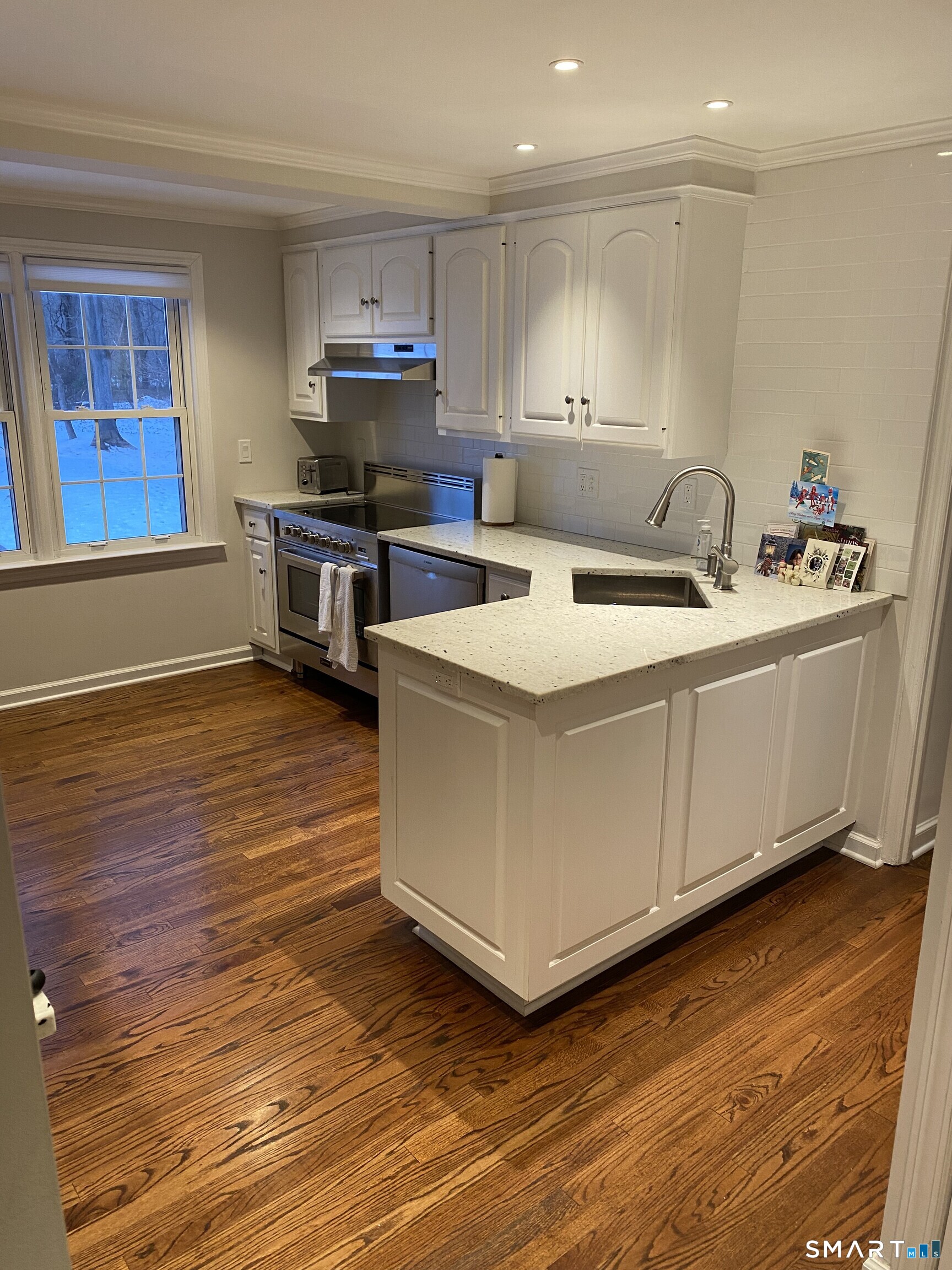 276 Dunnlea Road Fairfield, CT 06824 - Photo 9 of 26 a kitchen with stainless steel appliances granite countertop a sink a stove and a refrigerator