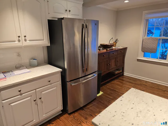 a kitchen with a refrigerator sink and cabinets
