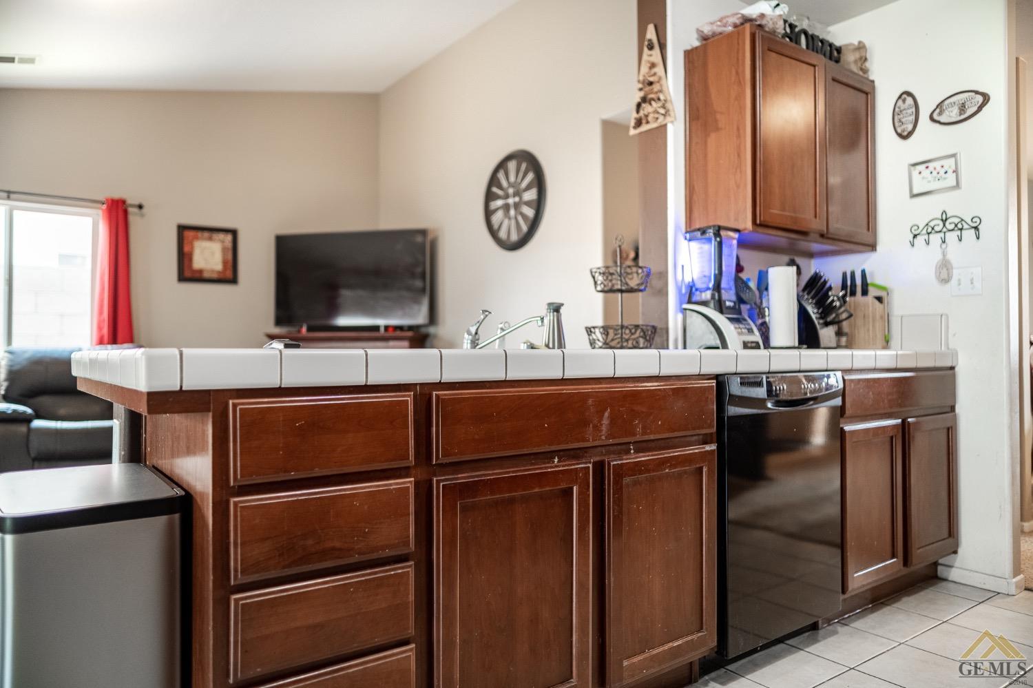 Undisclosed Address Bakersfield, CA 93311 - Photo 14 of 26 a living room with stainless steel appliances furniture a clock and a view of bathroom