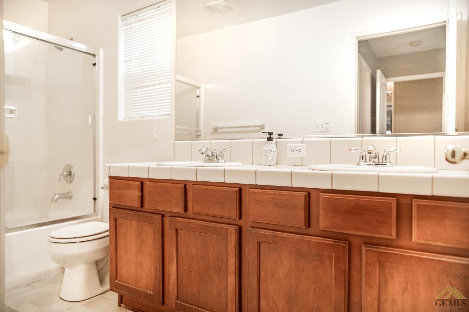 Undisclosed Address Bakersfield, CA 93311 - Photo 21 of 26 a bathroom with a sink a toilet and shower