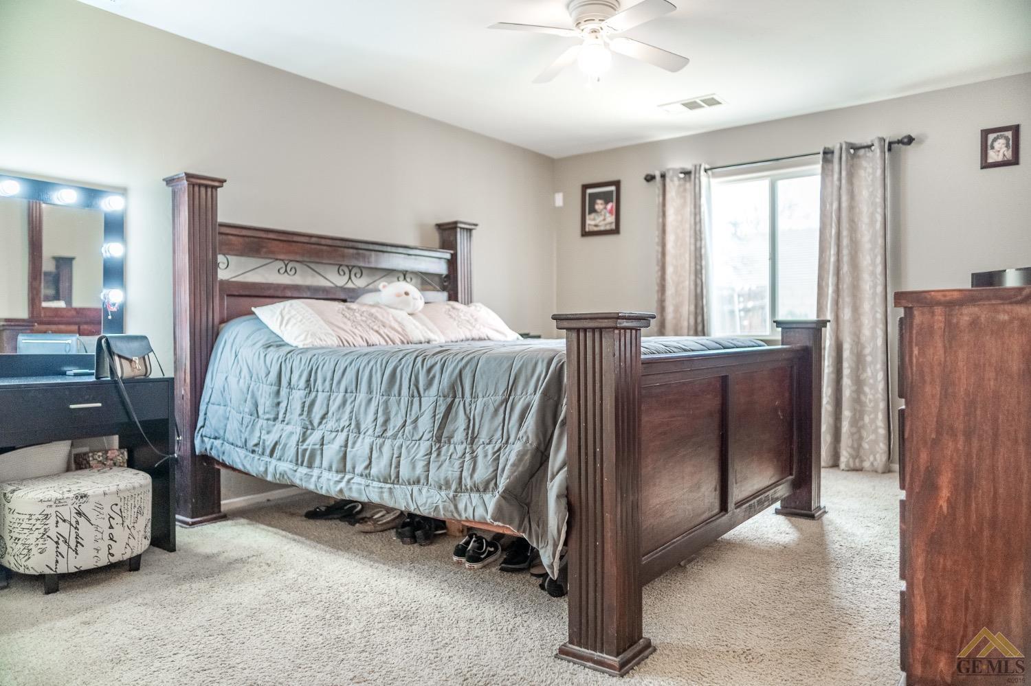 Undisclosed Address Bakersfield, CA 93311 - Photo 22 of 26 a bedroom with a bed and a mirror