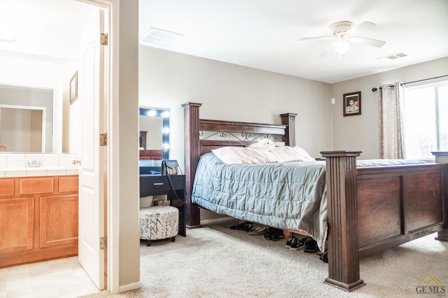 Undisclosed Address Bakersfield, CA 93311 - Photo 23 of 26 a bedroom with a bed and a cabinets