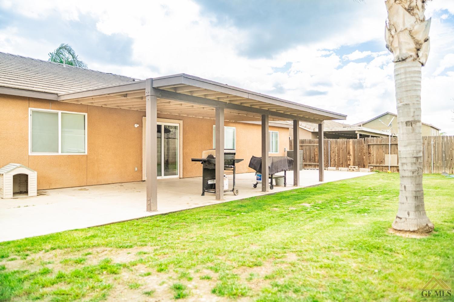 Undisclosed Address Bakersfield, CA 93311 - Photo 26 of 26 a view of a house with a backyard and a patio