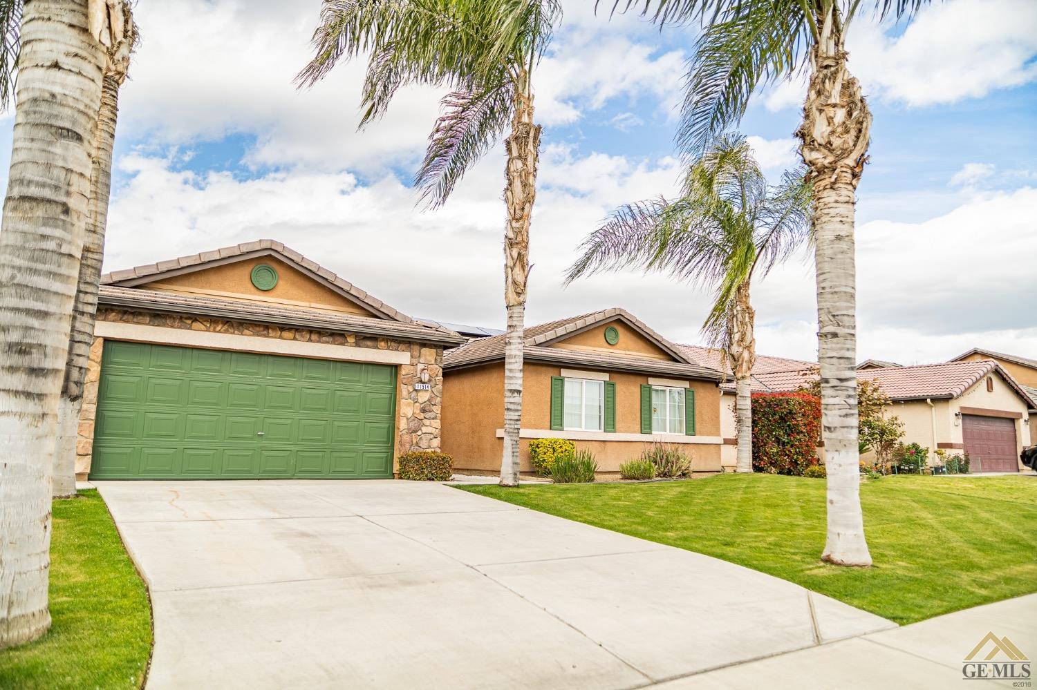 Undisclosed Address Bakersfield, CA 93311 - Photo 5 of 26 a front view of a house with a yard and garage