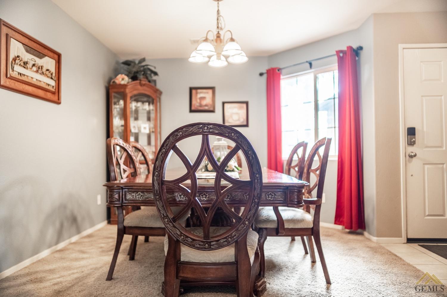 Undisclosed Address Bakersfield, CA 93311 - Photo 7 of 26 a view of a dining room with furniture and a chandelier