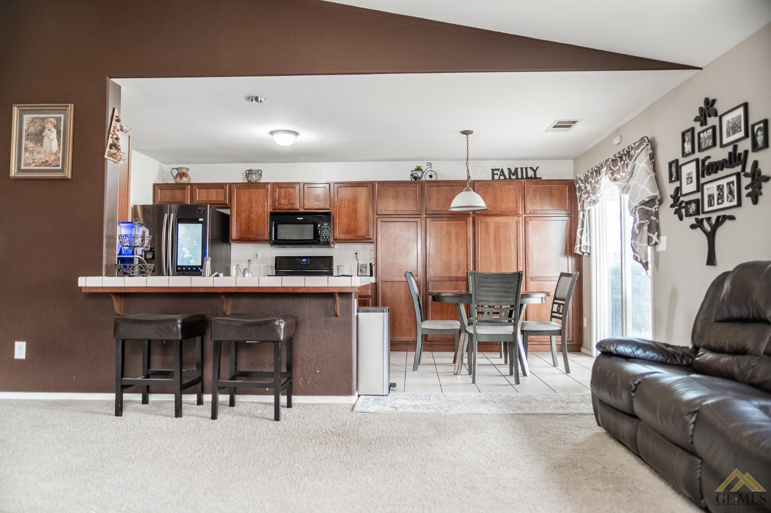 Undisclosed Address Bakersfield, CA 93311 - Photo 10 of 26 a living room with kitchen furniture and a kitchen view