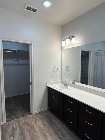 a spacious bathroom with a double vanity sink and a mirror