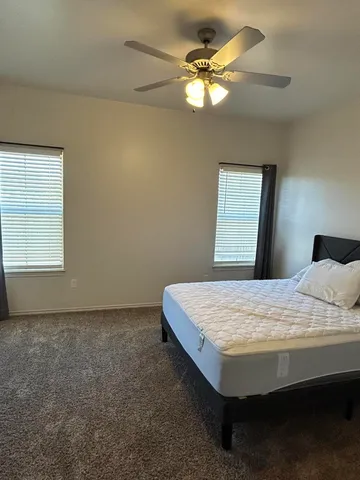 a bed sitting in a bedroom next to a window
