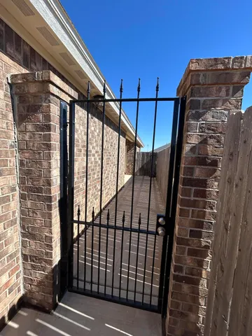 a view of staircase with railing and white walls