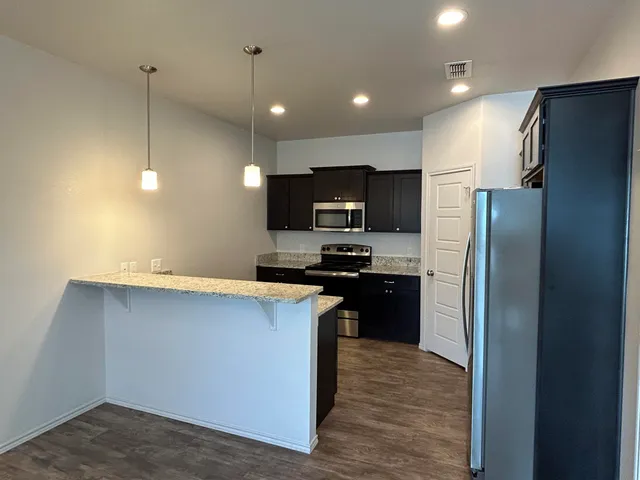 a kitchen with stainless steel appliances a refrigerator and a sink