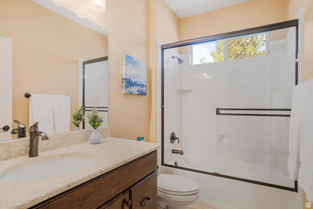 1587 Whitestone Drive St. George, UT 84790 - Photo 17 of 36 Bathroom featuring a vanity with an integrated sink, a light-toned countertop, and dark wood-finish cabinetry