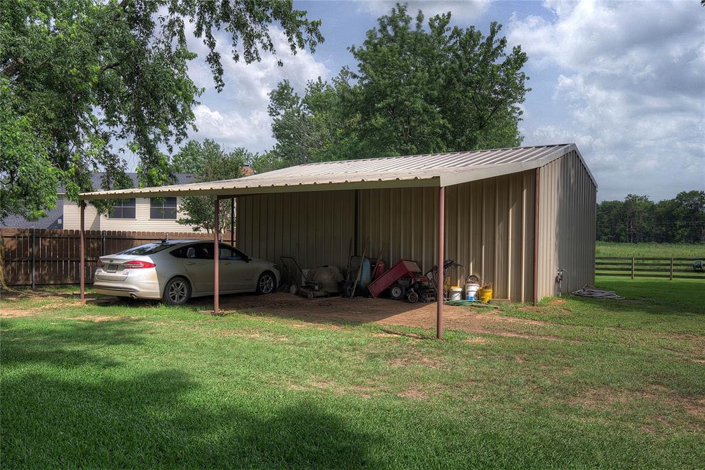 753 County Rd SW 3110 Mount Vernon, TX 75457 - Photo 36 of 40 behind the workshop is on overhang for equipment or extra vehicles.