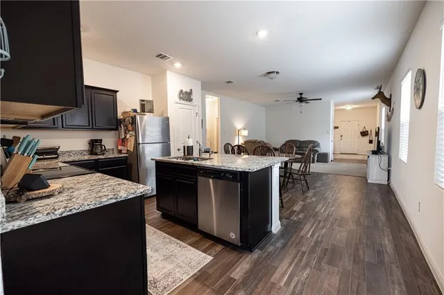 a kitchen with a sink a counter top space and stainless steel appliances