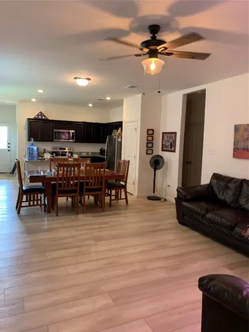 a living room with furniture and kitchen view