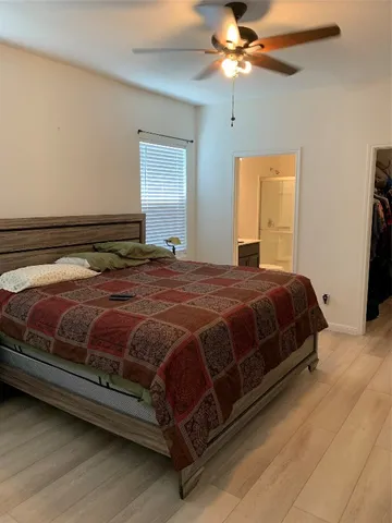 a bedroom with a bed and window