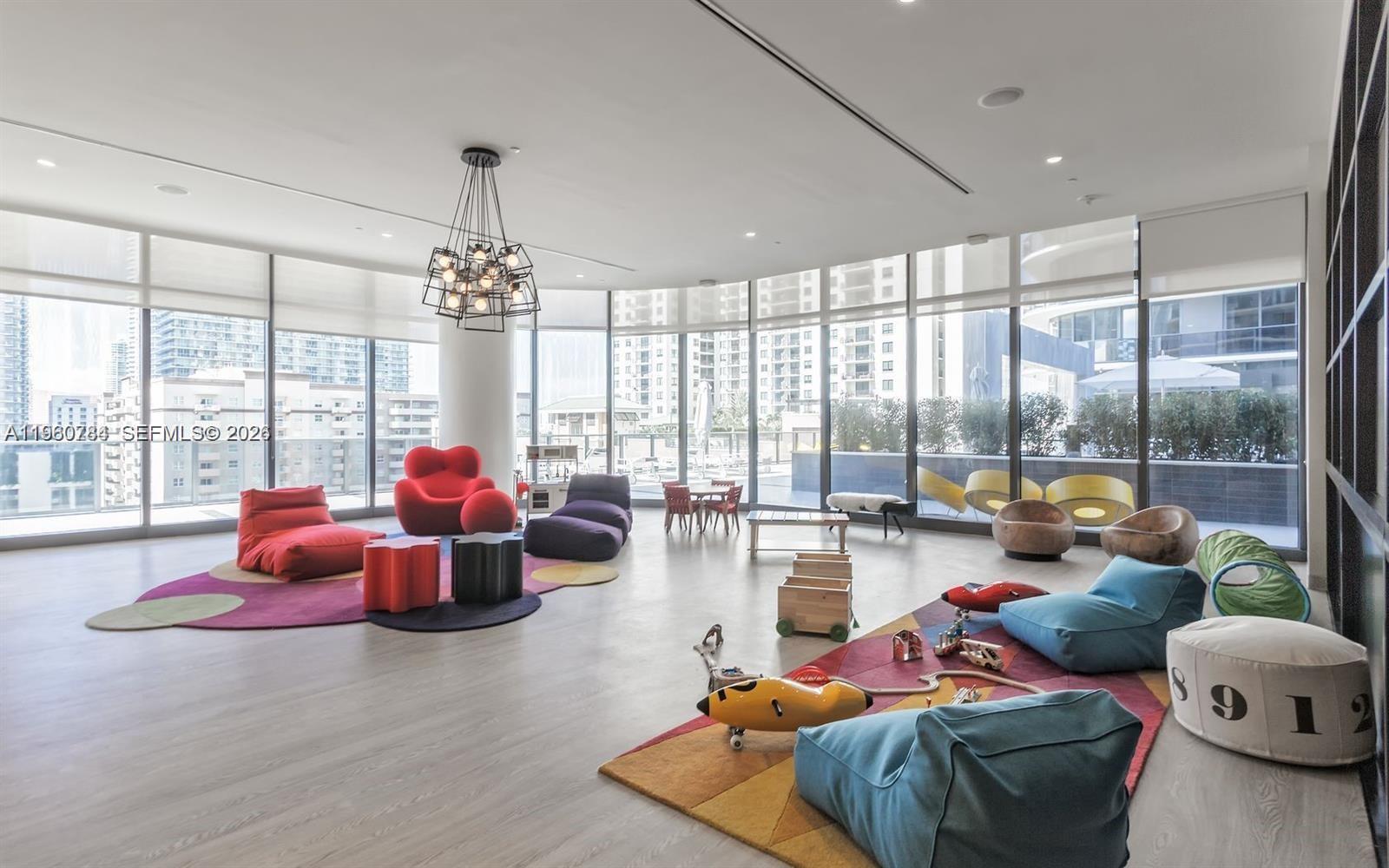 45 Southwest 9th Street, Unit 1805 Miami, FL 33130 - Photo 18 of 22 a living room with furniture and floor to ceiling windows