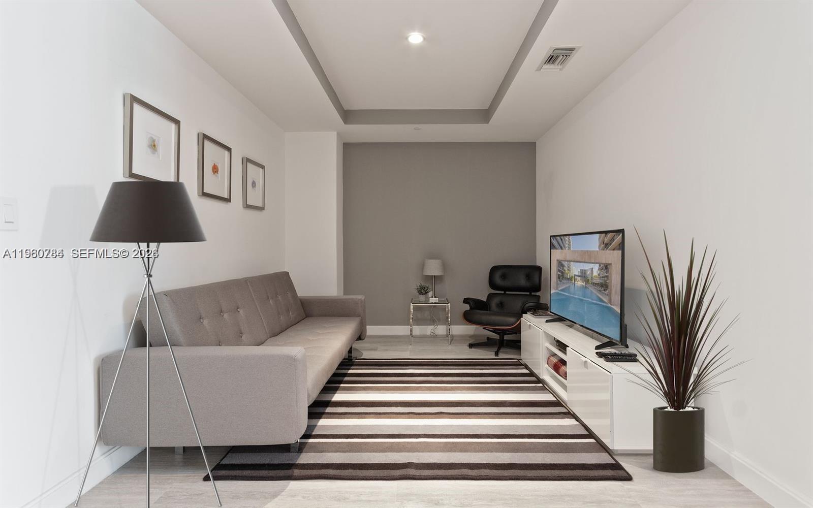 45 Southwest 9th Street, Unit 1805 Miami, FL 33130 - Photo 3 of 22 a living room with furniture and a rug