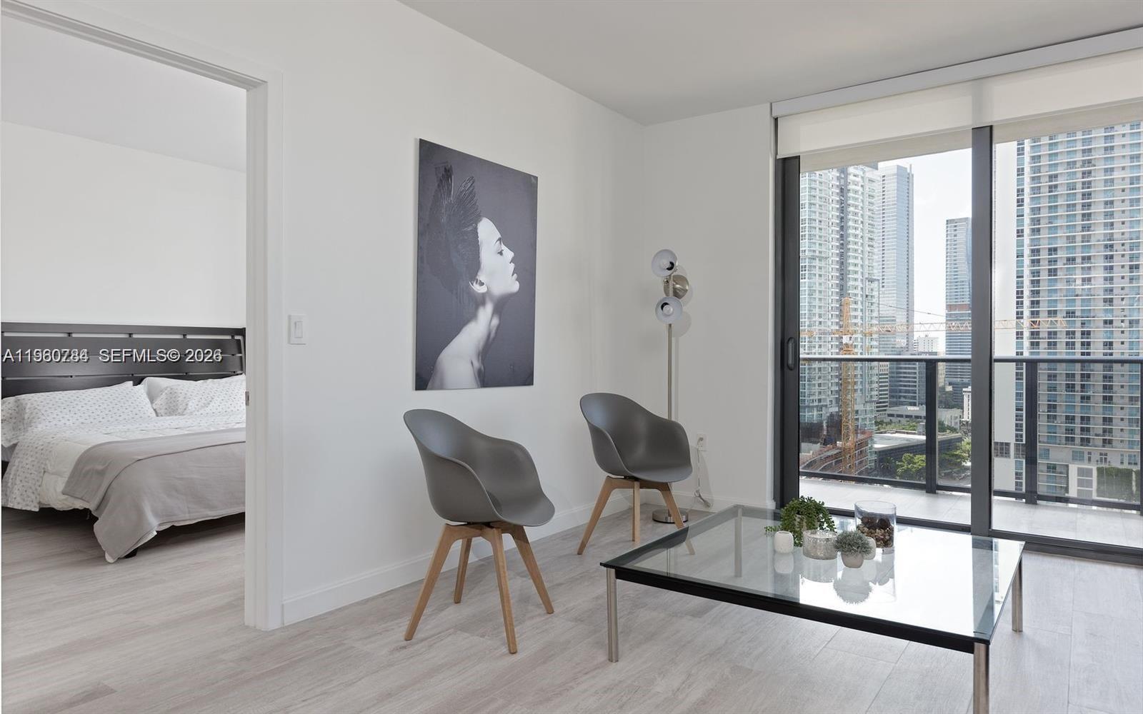 45 Southwest 9th Street, Unit 1805 Miami, FL 33130 - Photo 5 of 22 a living room with furniture and a window