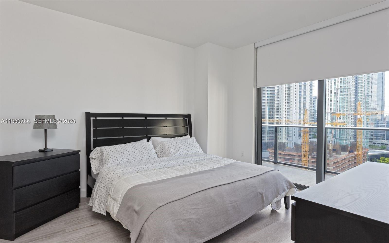 45 Southwest 9th Street, Unit 1805 Miami, FL 33130 - Photo 6 of 22 a bedroom with a bed and a window