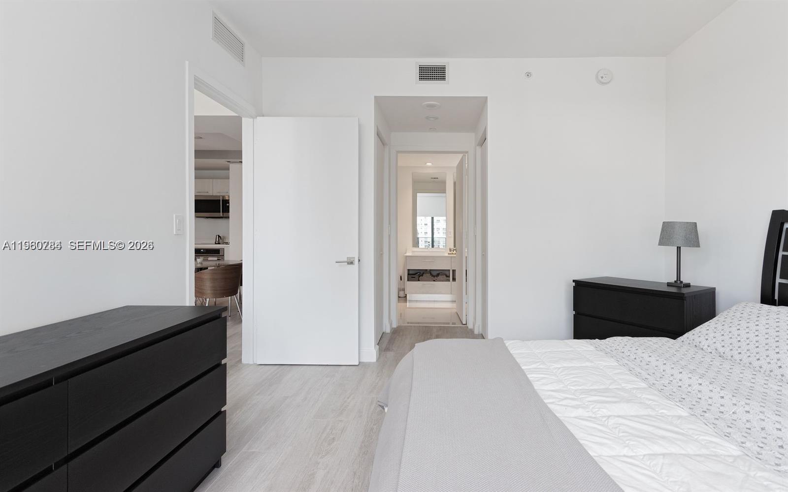 45 Southwest 9th Street, Unit 1805 Miami, FL 33130 - Photo 7 of 22 a bedroom with a bed and a cabinets