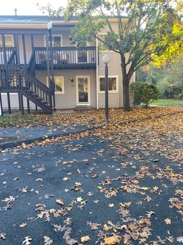 a front view of a house with a tree