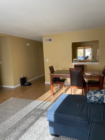 a living room with furniture and a piano