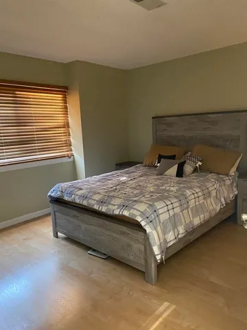 a bedroom with a bed and window