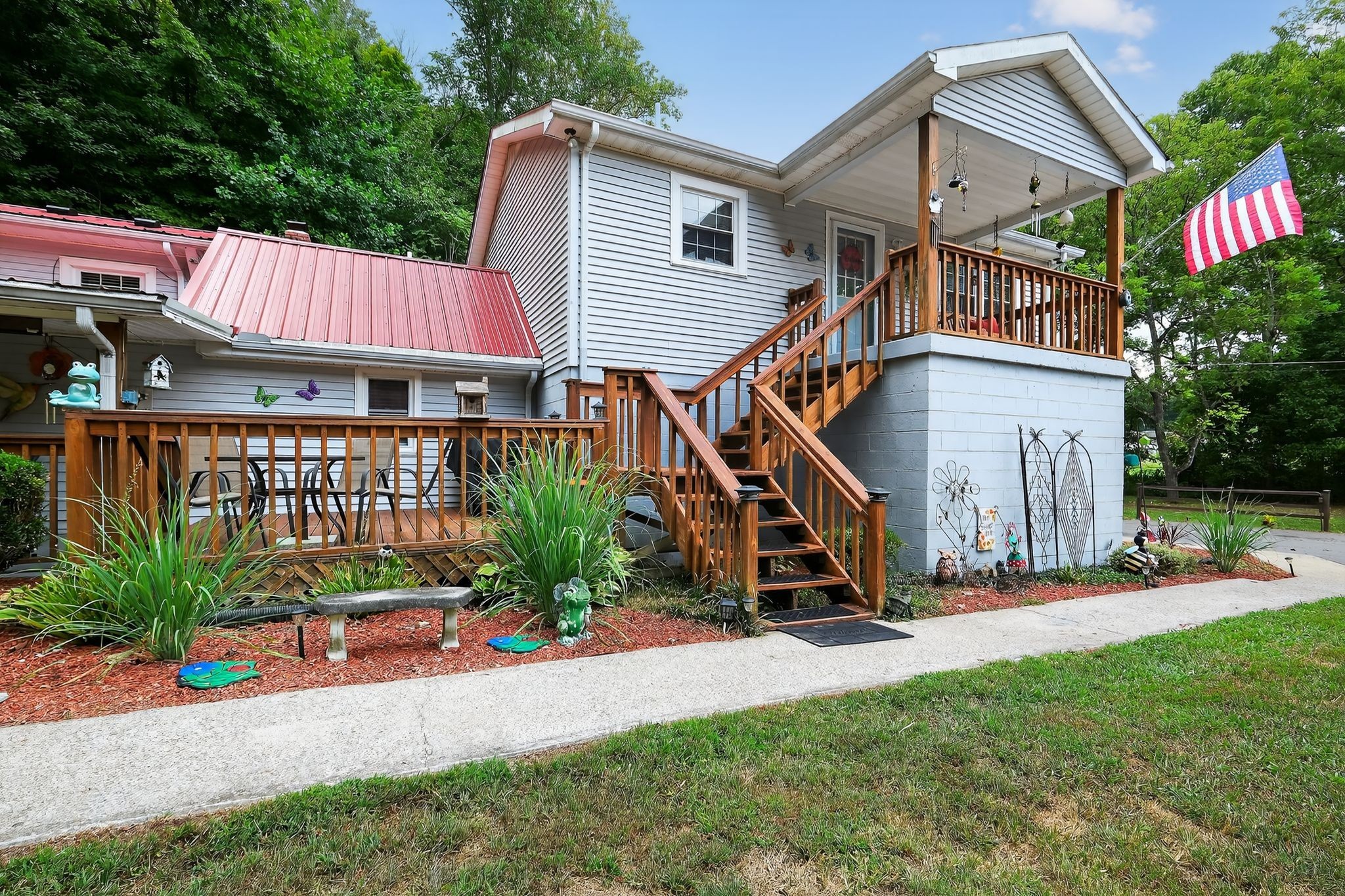 a view of a house with a small yard and potted plants