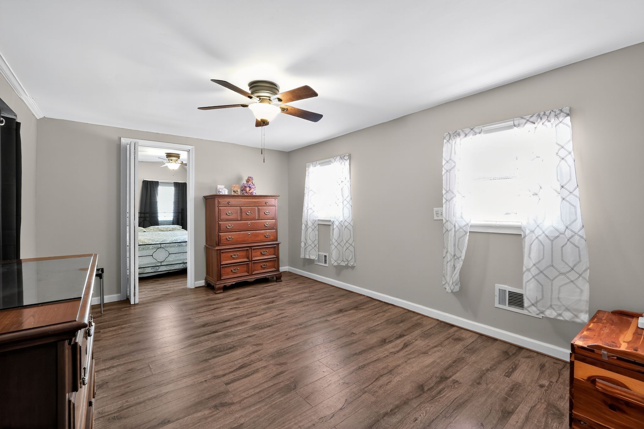 3119 Tyree Springs Road Hendersonville, TN 37075 - Photo 15 of 61 a view of a livingroom with a flat screen tv wooden floor and a ceiling fan