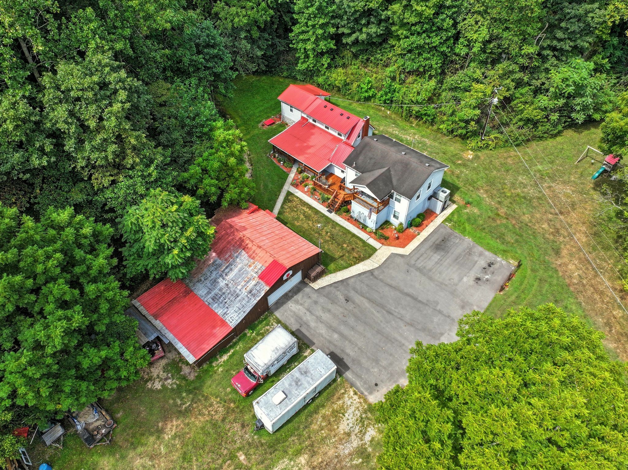3119 Tyree Springs Road Hendersonville, TN 37075 - Photo 3 of 61 an aerial view of a house with swimming pool and red chairs