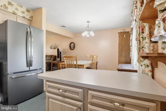 a dining room with furniture a chandelier and window