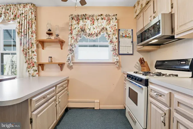 a kitchen with stainless steel appliances a refrigerator sink and microwave