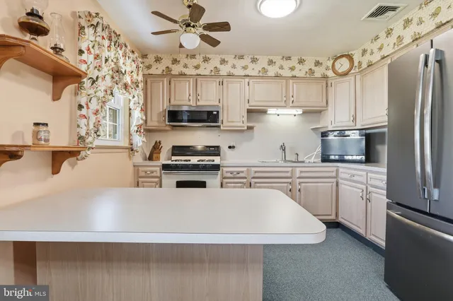 a view of hallway with a bathroom and a sink