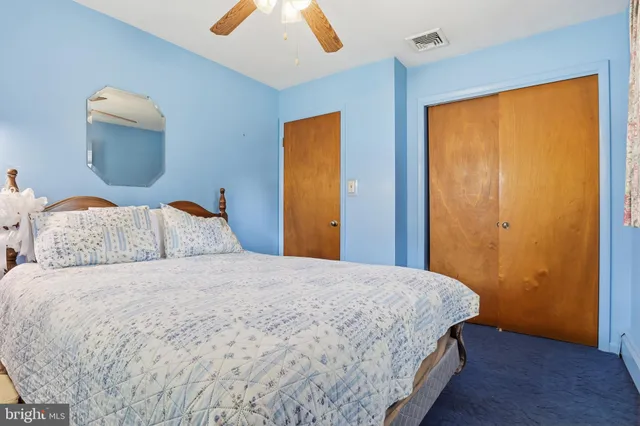 a bedroom with a bed and a night stand