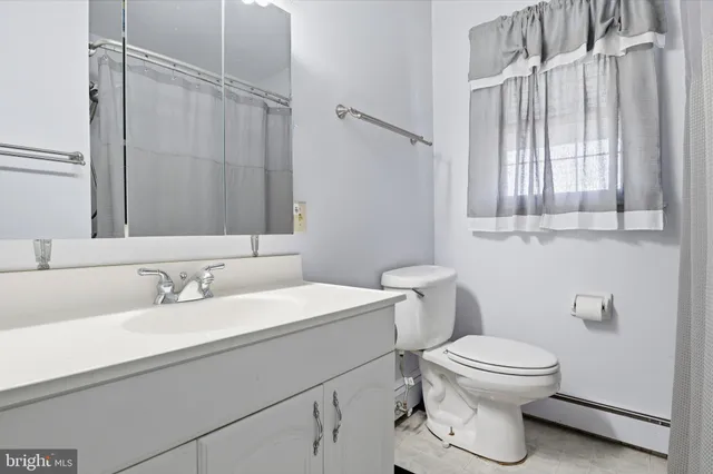 a view of a livingroom with workspace and a window