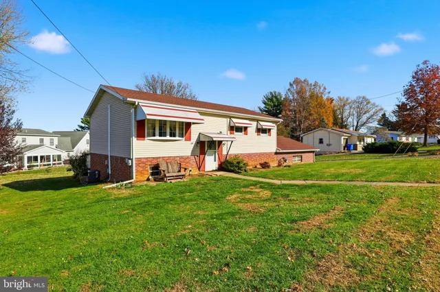 a front view of house with yard and green space