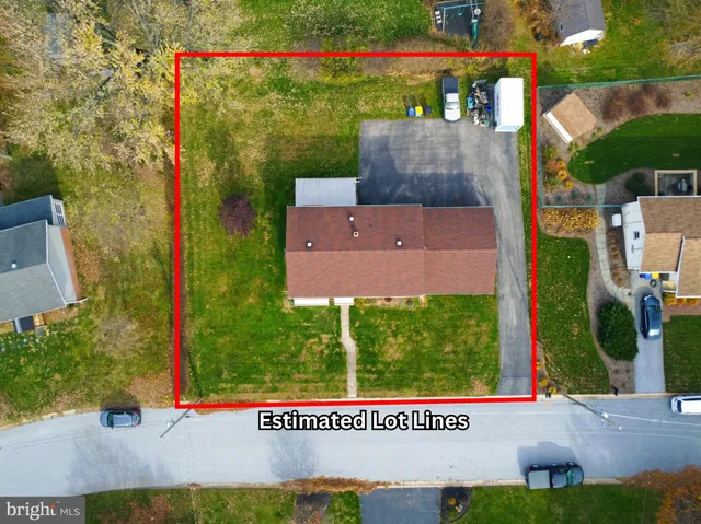 an aerial view of a house with a garden and lake view