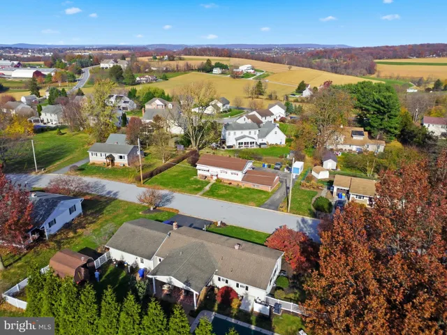 an aerial view of residential houses with outdoor space
