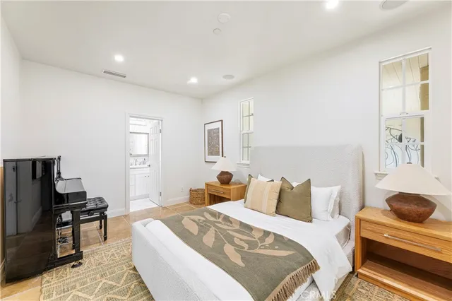 a kitchen with stainless steel appliances kitchen island granite countertop a refrigerator and a view of living room