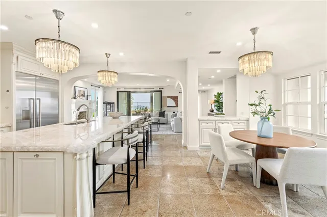 a view of a patio with couches chairs and a table with potted plants