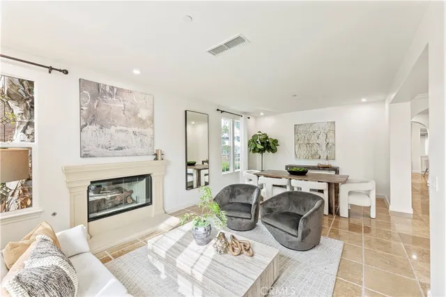 a living room with furniture potted plant and a large window