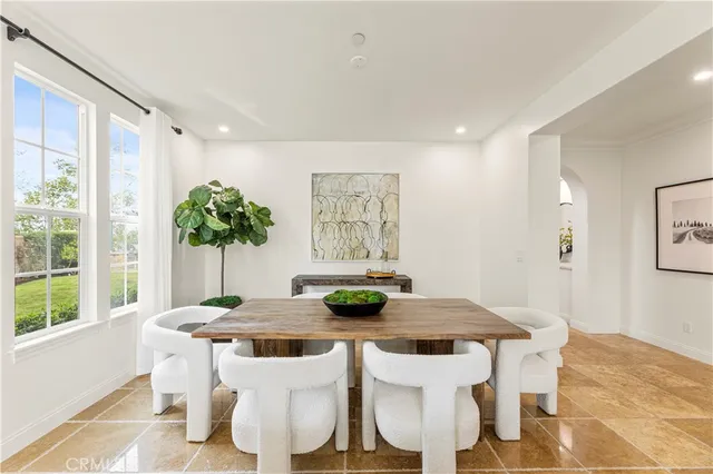 a living room with furniture and a painting on the wall